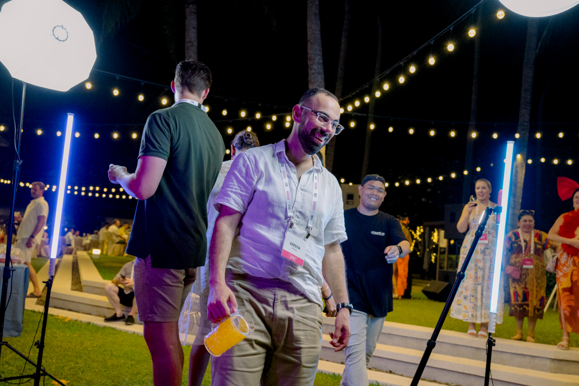 EO Melbourne members laughing and dancing together under festoon lights at the EO Melbourne Chapter Retreat Phuket 2025